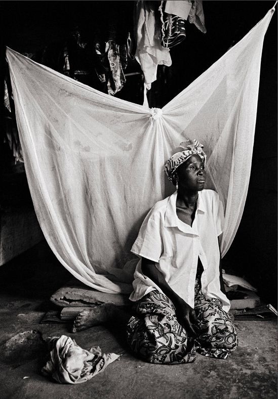 1 января 2011 года. –Провинция Куритенга, Буркина-Фасо – Сорокадвухлетняя Аджрата около вывешенного постиранного белья. Она ВИЧ-инфицирована уже в течение восьми лет. Брат ее мужа обнаружил результаты ее анализов, и теперь не дает ей принимать никаких лекарств.