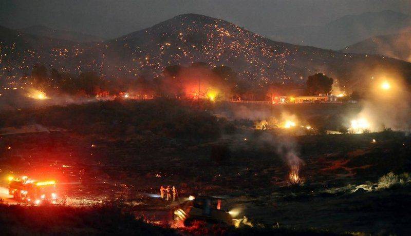 Холмы Эктон в штате Калифорния в зареве пламени 30 августа – это только часть огромного пожара, который охватил Национальный лесной парк Анджелес, к северу от Лос-Анджелеса.