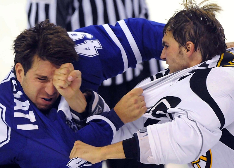 Игрок из команды «Toronto Maple Leafs» Стефано Жилиати, слева, и член команды «Boston Bruins» Джордан Накстедт дерутся во время игры турнира НХЛ в Китченер, Онтарио, Канада