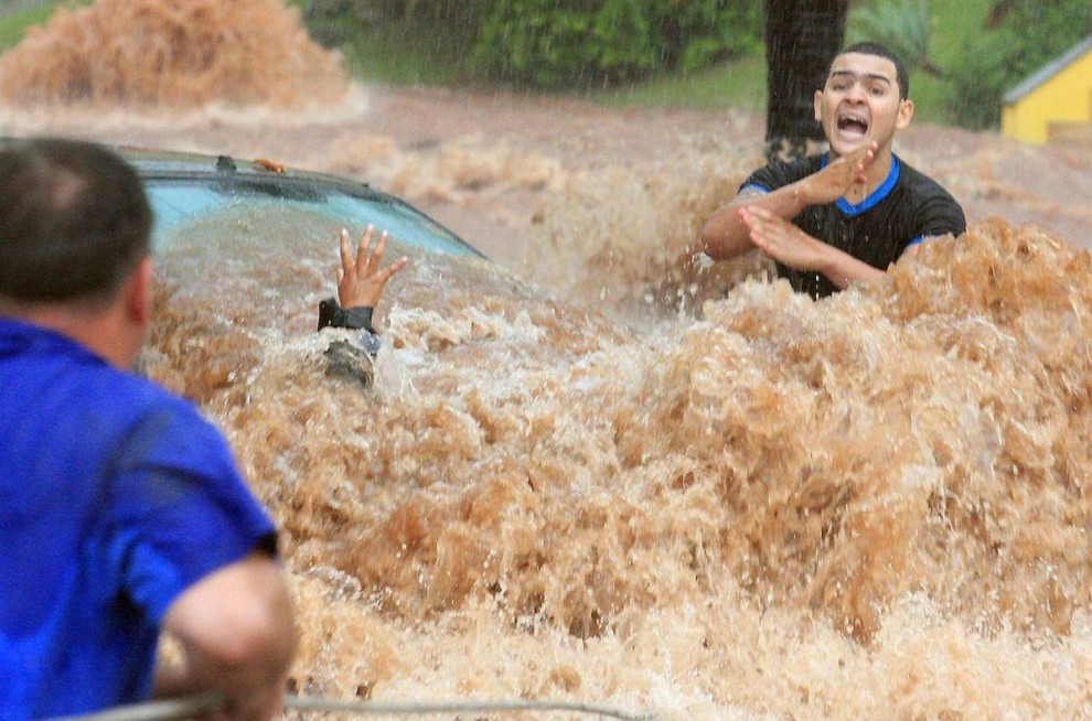 Автомобилисты во время наводнения, причиной которых стали сильные дожди. Снимок сделан в Сан-Жозе-ду-Риу-Прету, Бразилия.