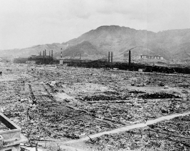 Этот район Нагасаки когда-то был застроен промышленными зданиями и небольшими жилыми домами. На заднем плане видны руины завода Мицубиши и бетонного здания школы, находившегося у подножья холма.