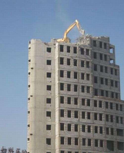 Экскаватор разрушает здания (6 фото)