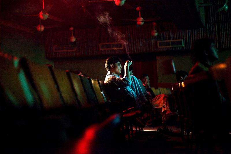 Мужчина смотрит фильм «Боль души» в кинотеатре в Пешаваре, Пакистан. Работники кинотеатров говорят, что из-за угрозы терактов люди перестали ходить на работу и теперь ходят в кино, благодаря чему вырос доход кинотеатров.